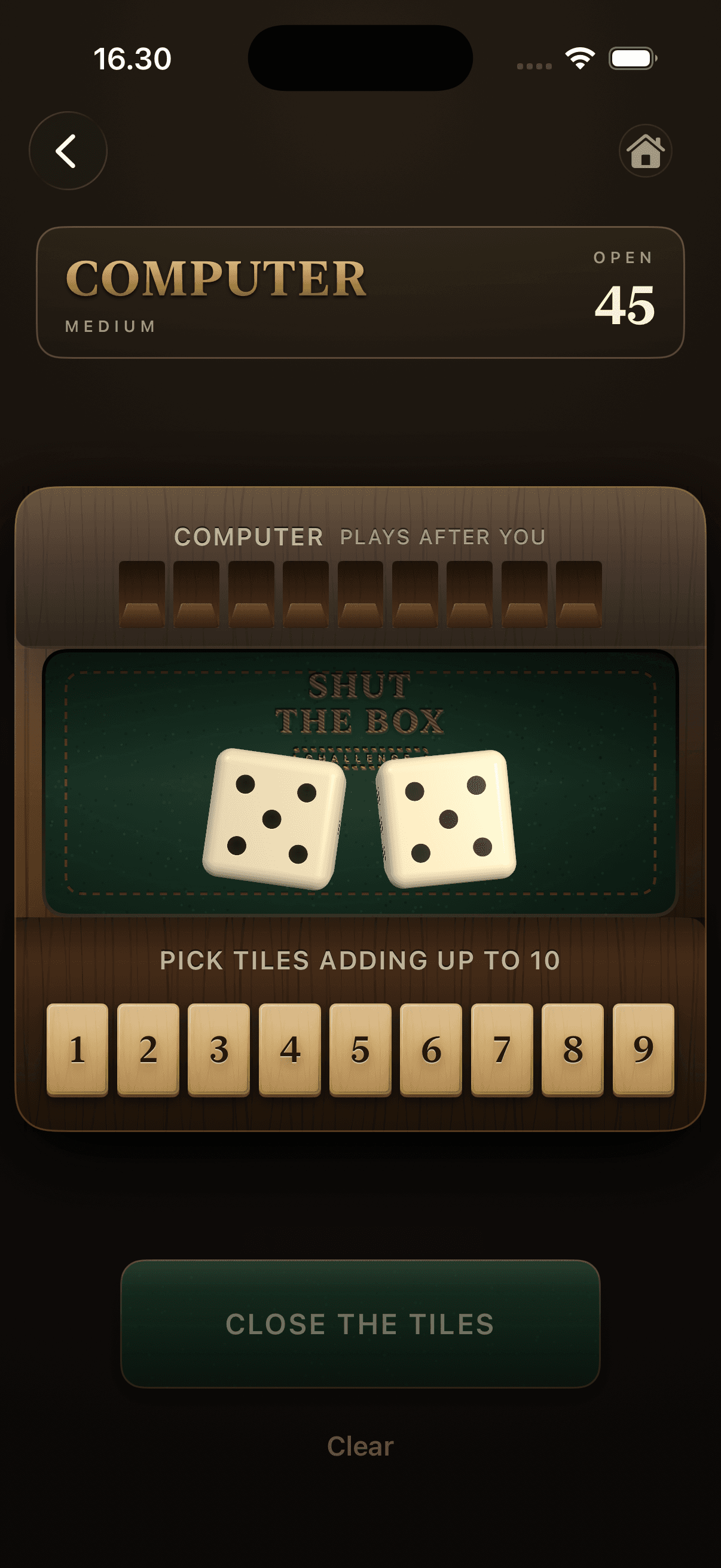 The wooden box mid-round: two dice showing ten, the nine numbered tiles still open, and the computer's row waiting above